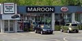 Maroon Kia Service logo