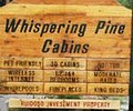Whispering Pine Cabins logo